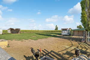 View of yard featuring a view of countryside and a storage shed