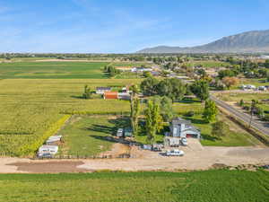 Aerial view of sparsely populated area with a mountainous background and rows of crops