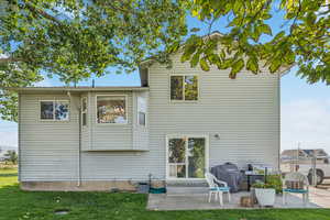 Back of house with a patio area