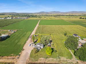 Overview of rural landscape with a mountain backdrop and farmland