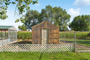 View of outbuilding with a garden and a sunroom