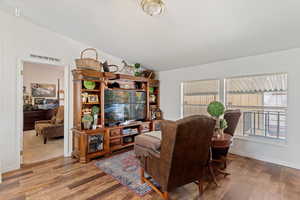 Living room featuring wood finished floors and vaulted ceiling