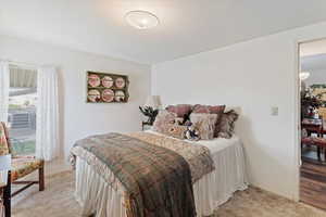 Bedroom featuring baseboards and light carpet