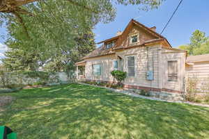 Rear view of property featuring a chimney