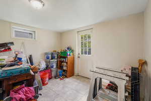 Basement entry featuring light tile patterned floors