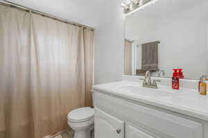 Bathroom featuring vanity, light tile patterned floors, and a shower with shower curtain