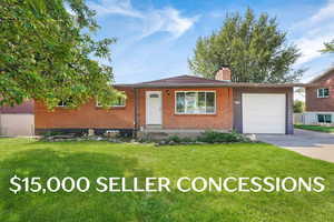 Ranch-style house featuring brick siding, a front yard, a chimney, an attached garage, and driveway
