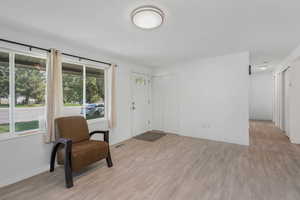 Living room with light wood-type flooring and baseboards