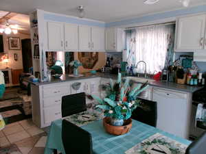 Kitchen featuring white cabinets, stainless steel range oven, dishwasher, dark countertops, and ceiling fan