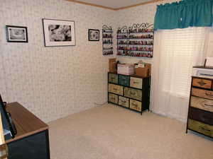 Sitting room featuring light carpet, and wallpapered walls