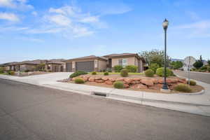 View of front facade with driveway, an attached garage, and stucco siding