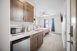 Bedroom with light carpet and ceiling fan