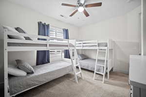 Bedroom featuring light colored carpet and ceiling fan