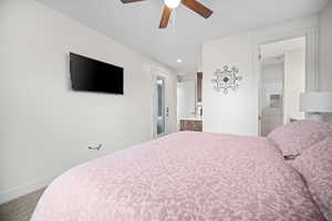 Carpeted bedroom with ensuite bath, a ceiling fan, and recessed lighting