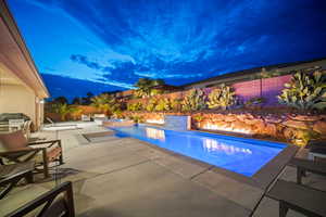 View of pool with a fenced backyard, a patio, and a pool with connected hot tub
