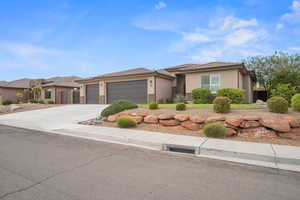 Prairie-style home with a garage, driveway, stucco siding, a tile roof, and stone siding