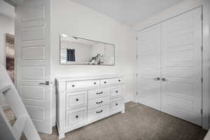 Unfurnished bedroom with carpet floors and a closet