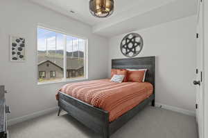 Bedroom featuring carpet flooring and baseboards