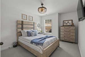 Bedroom featuring baseboards and carpet