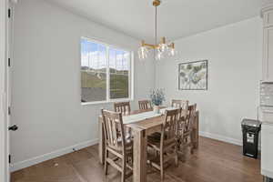 Dining space featuring light wood-type flooring and a chandelier
