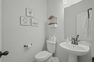 Bathroom with toilet and baseboards