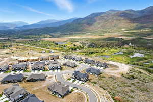Aerial overview of property's location with nearby suburban area and mountains