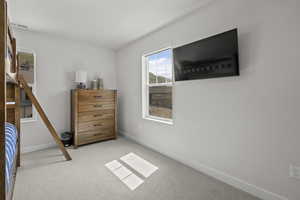Bedroom with carpet and baseboards