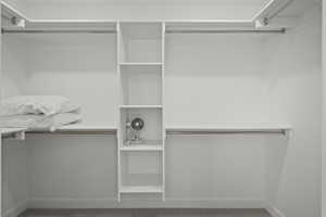 Walk in closet with carpet floors