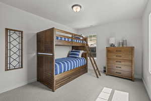 Carpeted bedroom featuring baseboards