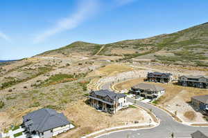 Aerial view of property's location featuring mountains and nearby suburban area