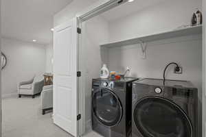 Washroom with carpet floors, recessed lighting, and washing machine and clothes dryer