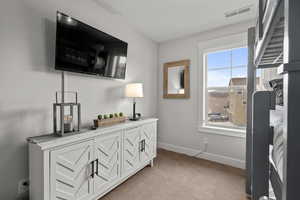 Detailed view of carpet flooring and baseboards