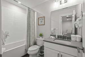 Full bathroom with shower / bath combo, vanity, and recessed lighting