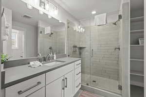 Full bath featuring vanity, a shower stall, and recessed lighting