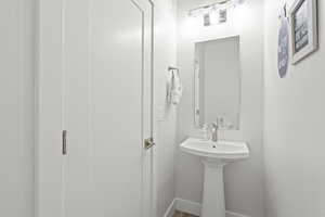Bathroom featuring baseboards and wood finished floors
