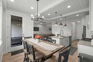 Dining space featuring light wood finished floors, beam ceiling, a ceiling fan, and recessed lighting