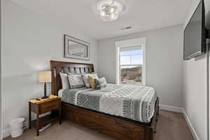 Carpeted bedroom with baseboards