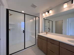 Owner's Bathroom with a stall shower, double vanity, recessed lighting, and light tile patterned flooring