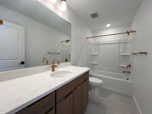 Secondary bathroom featuring bathtub / shower combination, vanity, and light tile patterned floors