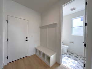 Mudroom featuring light wood-type flooring and baseboards