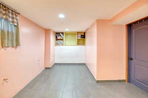 Corridor with recessed lighting and baseboards