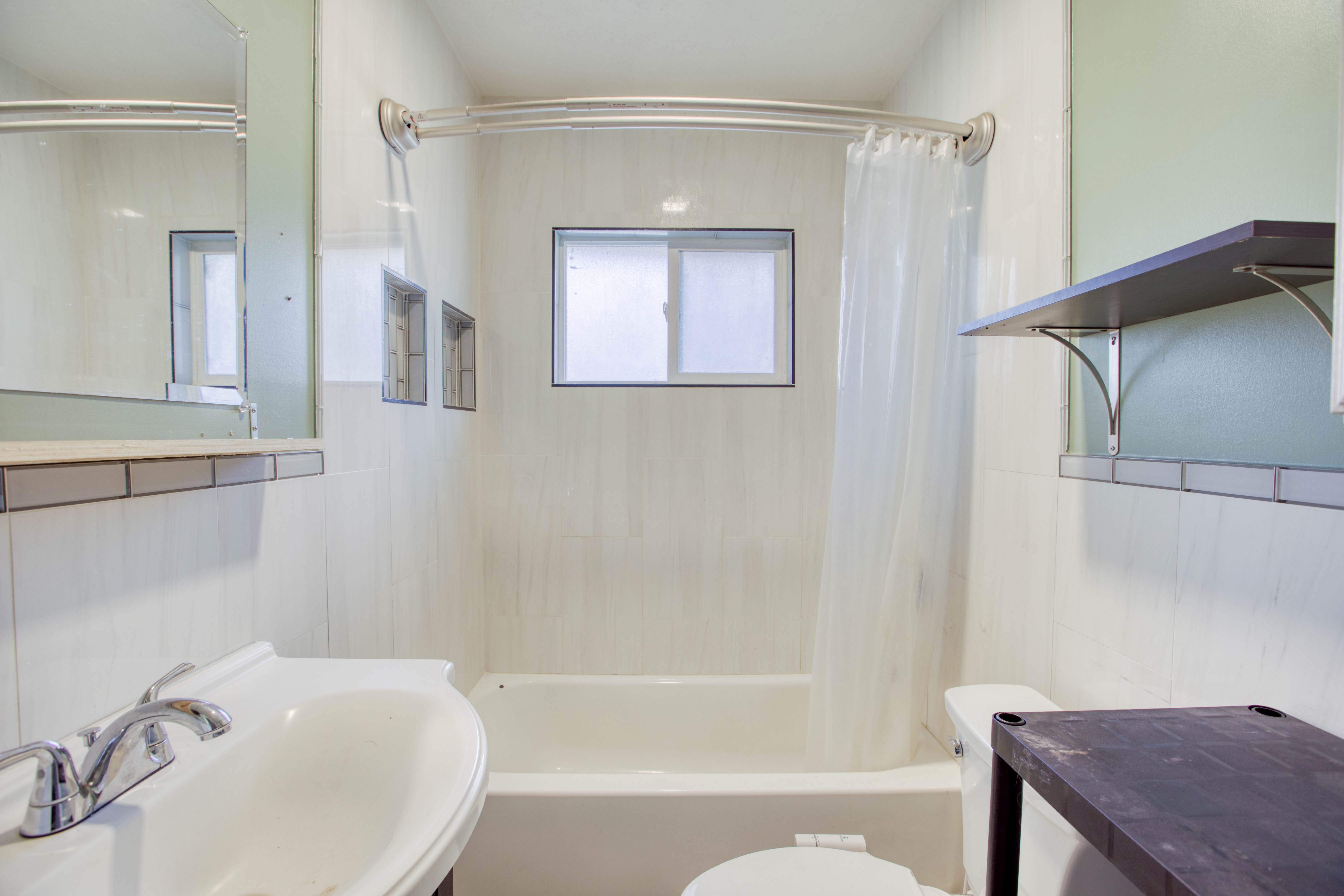 Full bath featuring shower / bath combo with shower curtain and vanity