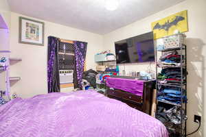 Bedroom featuring a textured ceiling