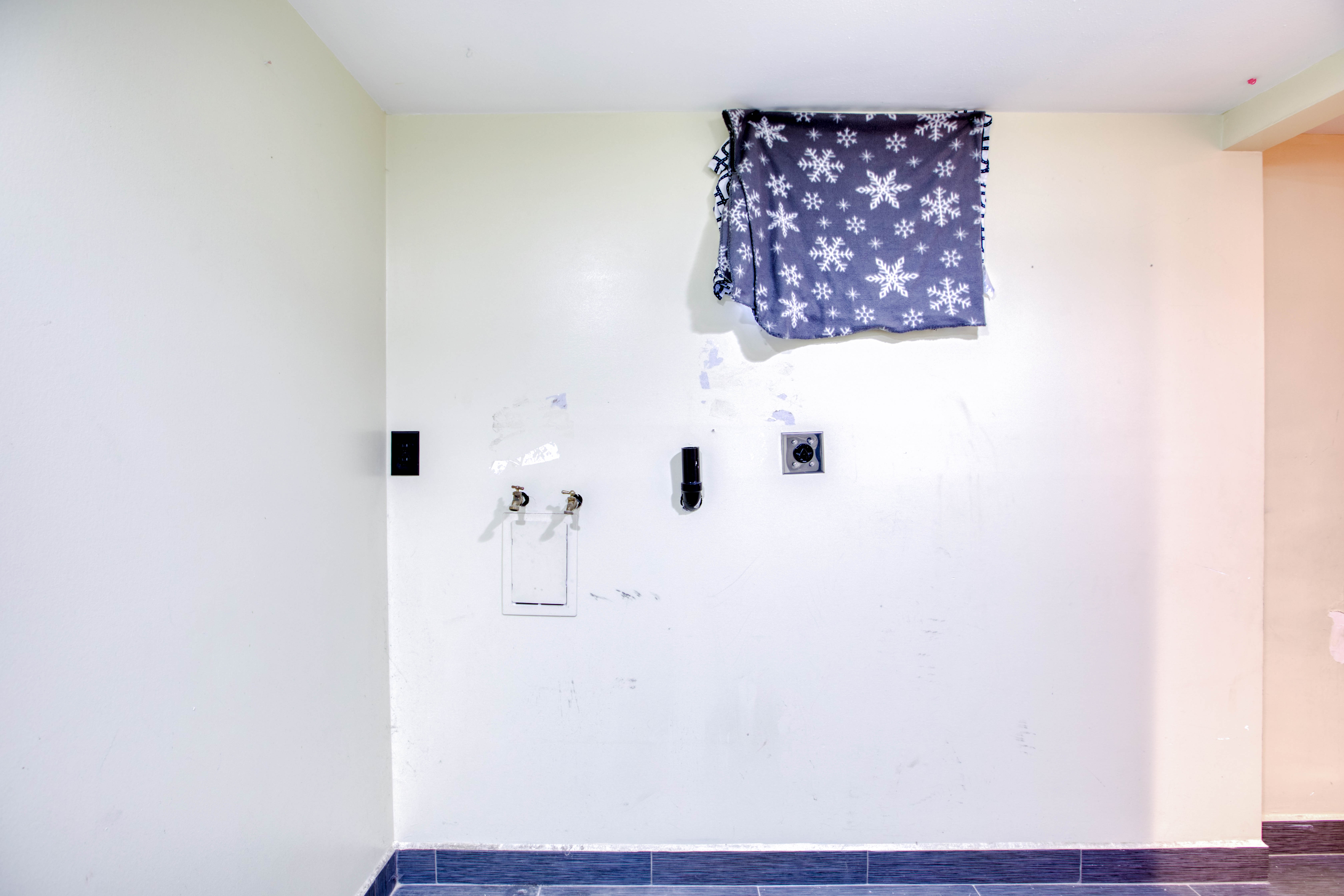 Laundry area with hookup for a washing machine and hookup for an electric dryer