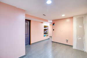 Empty room with recessed lighting and baseboards