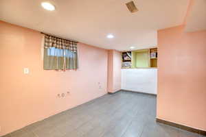 Finished below grade area with recessed lighting and baseboards