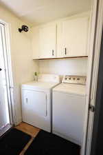 Laundry room with cabinet space and washer and dryer