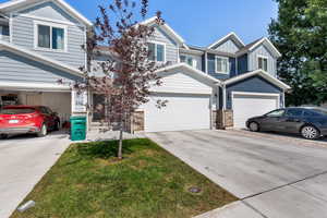 View of front of home with board and batten siding and concrete driveway