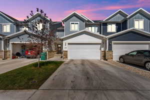 Craftsman inspired home with board and batten siding, driveway, and an attached garage