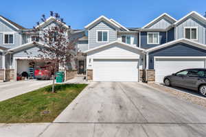 Craftsman-style home featuring board and batten siding and driveway